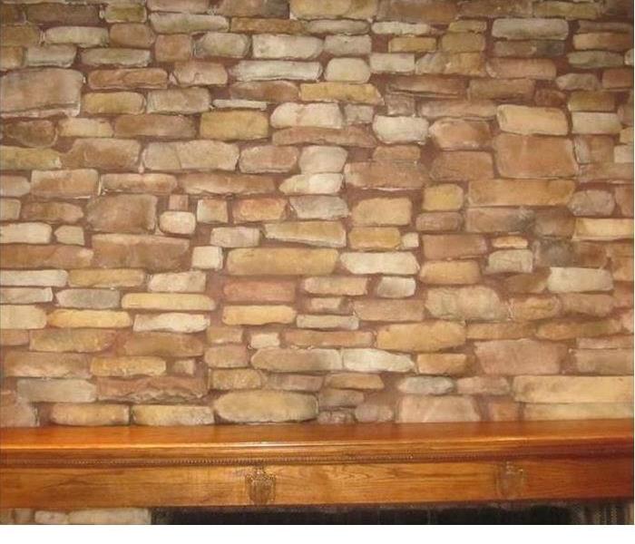 the stone area on a stone fireplace that was once stained by soot has been made clean